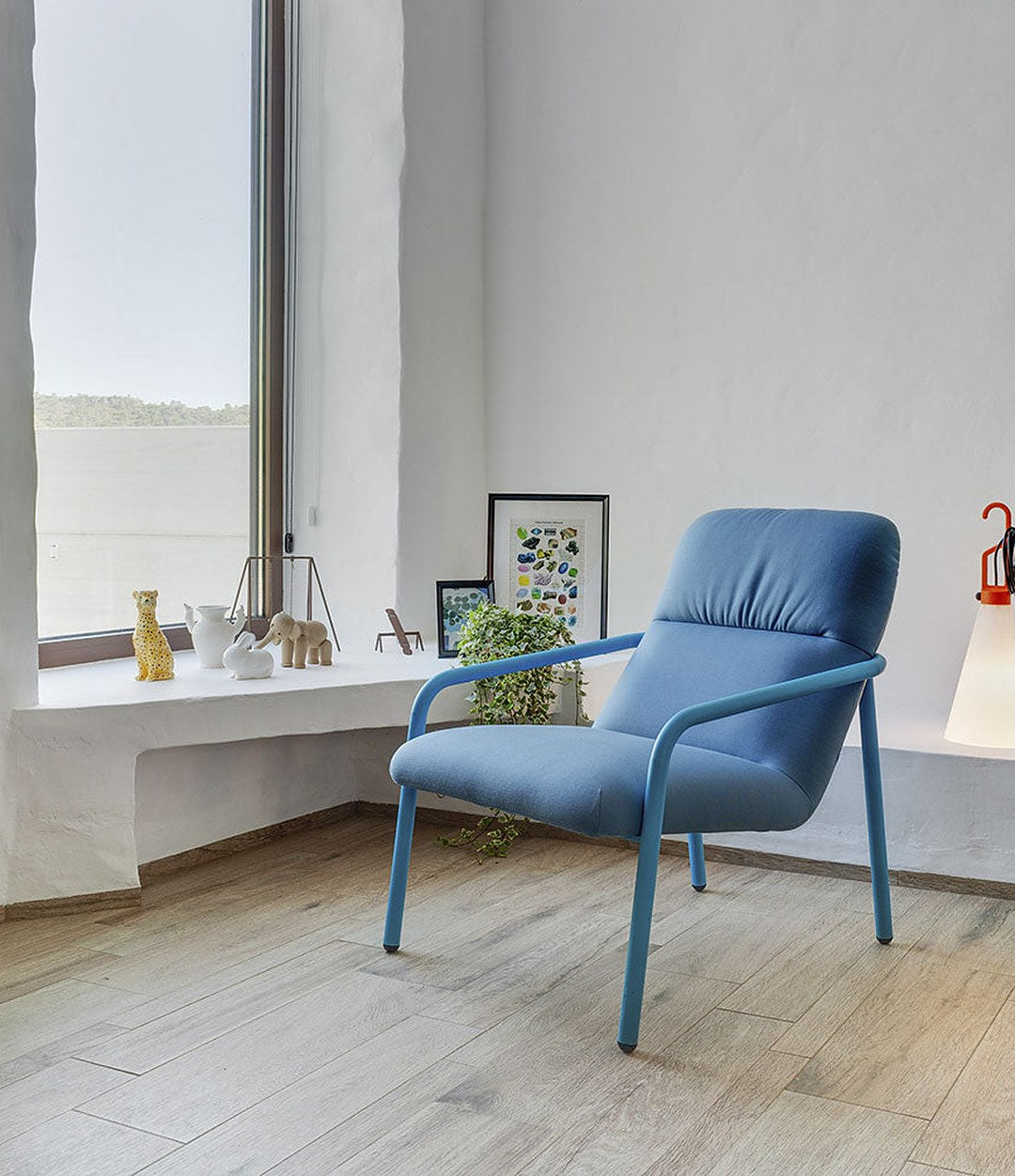Elle Wing Chair by Sancal in blue by a window – In Dubai by WSPR