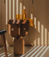 Faces Side Table by Sancal in dark oak in warm light – In Dubai by WSPR