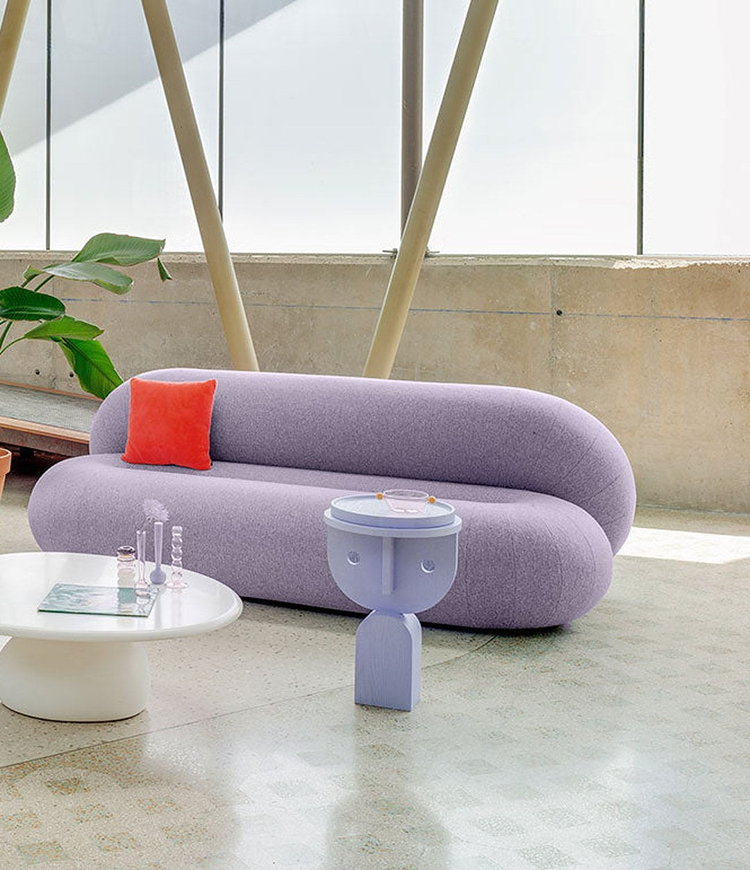 Faces Side Table by Sancal in lilac beside a curved sofa – In Dubai by WSPR