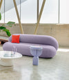 Faces Side Table by Sancal in lilac beside a curved sofa – In Dubai by WSPR