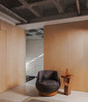 Faces Side Table by Sancal in dark oak beside a leather armchair – In Dubai by WSPR