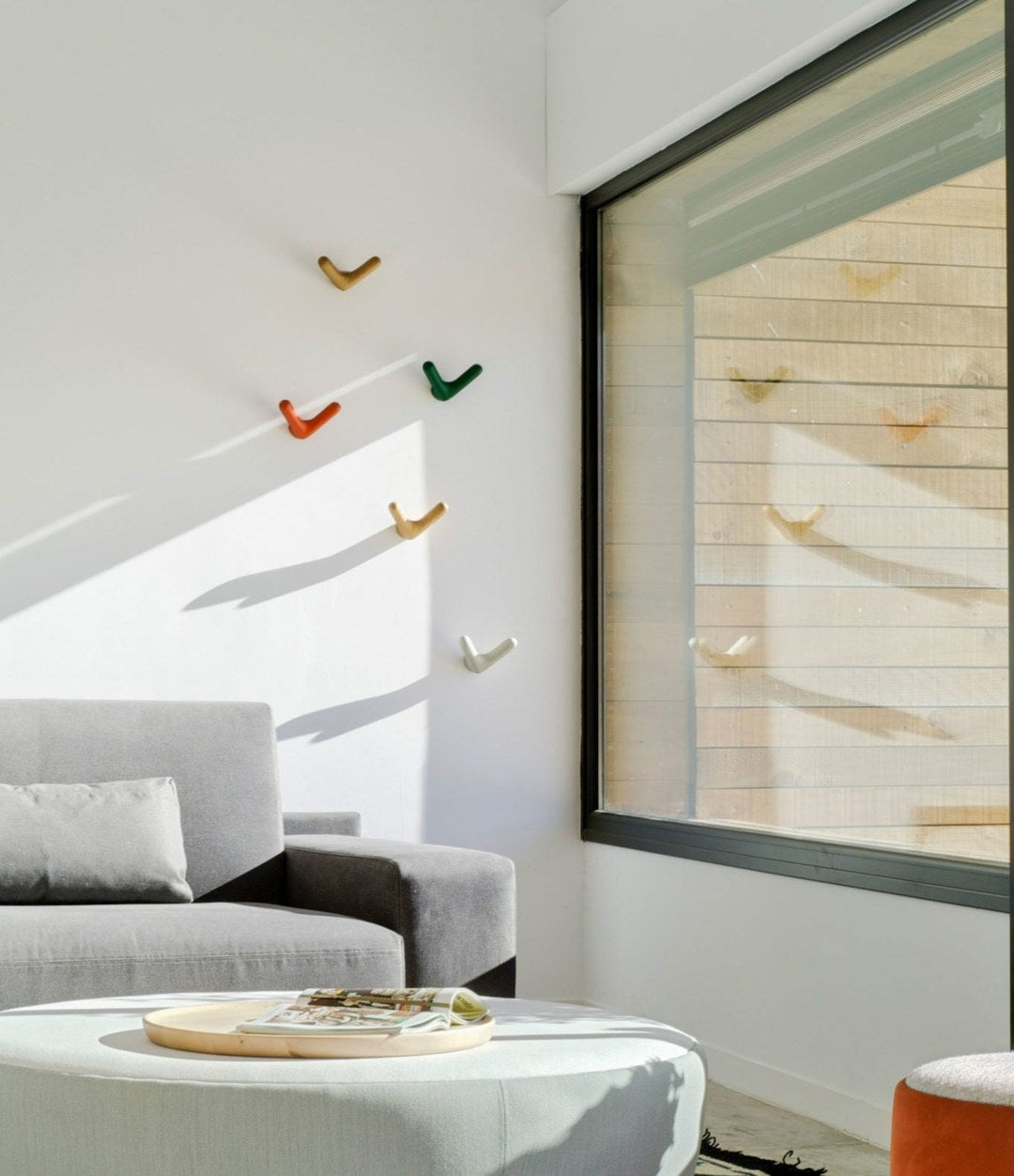 Float Wall Hook by Sancal a flock of hooks by a living room window – In Dubai by WSPR