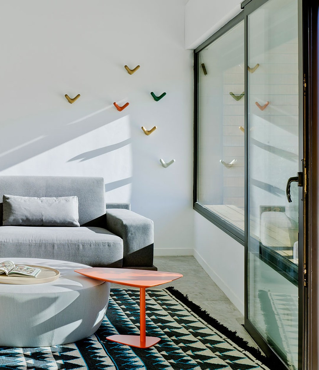 Float Wall Hook by Sancal hooks in several colours above a sofa – In Dubai by WSPR