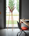 Game of Trust Coat Rack by Miniforms with red terminals, styled beside a window and a work desk – In Dubai by WSPR