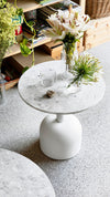 Illo Coffee Table by Miniforms styled with a vase of lilies on a speckled top – In Dubai by WSPR