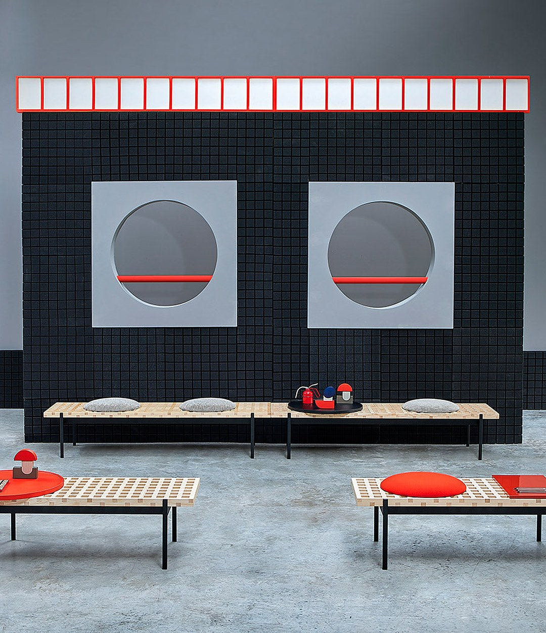 Interchange Bench by Sancal benches with red seats and tables in a gallery space – In Dubai by WSPR