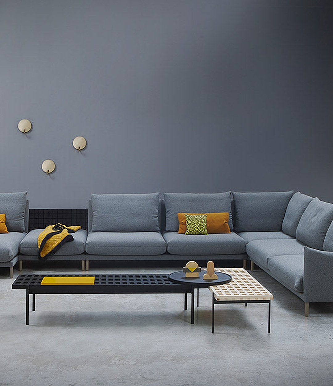 Interchange Bench by Sancal in black as a coffee table beside a sofa – In Dubai by WSPR