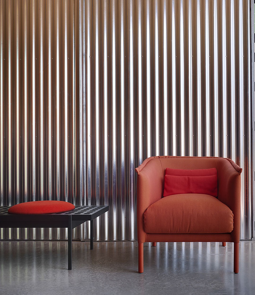 Interchange Bench by Sancal in black with a red seat beside an armchair – In Dubai by WSPR