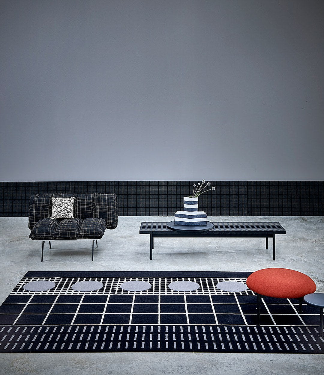 Interchange Bench by Sancal in black with a large red seat on a rug – In Dubai by WSPR