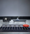 Interchange Bench by Sancal in black with a large red seat on a rug – In Dubai by WSPR