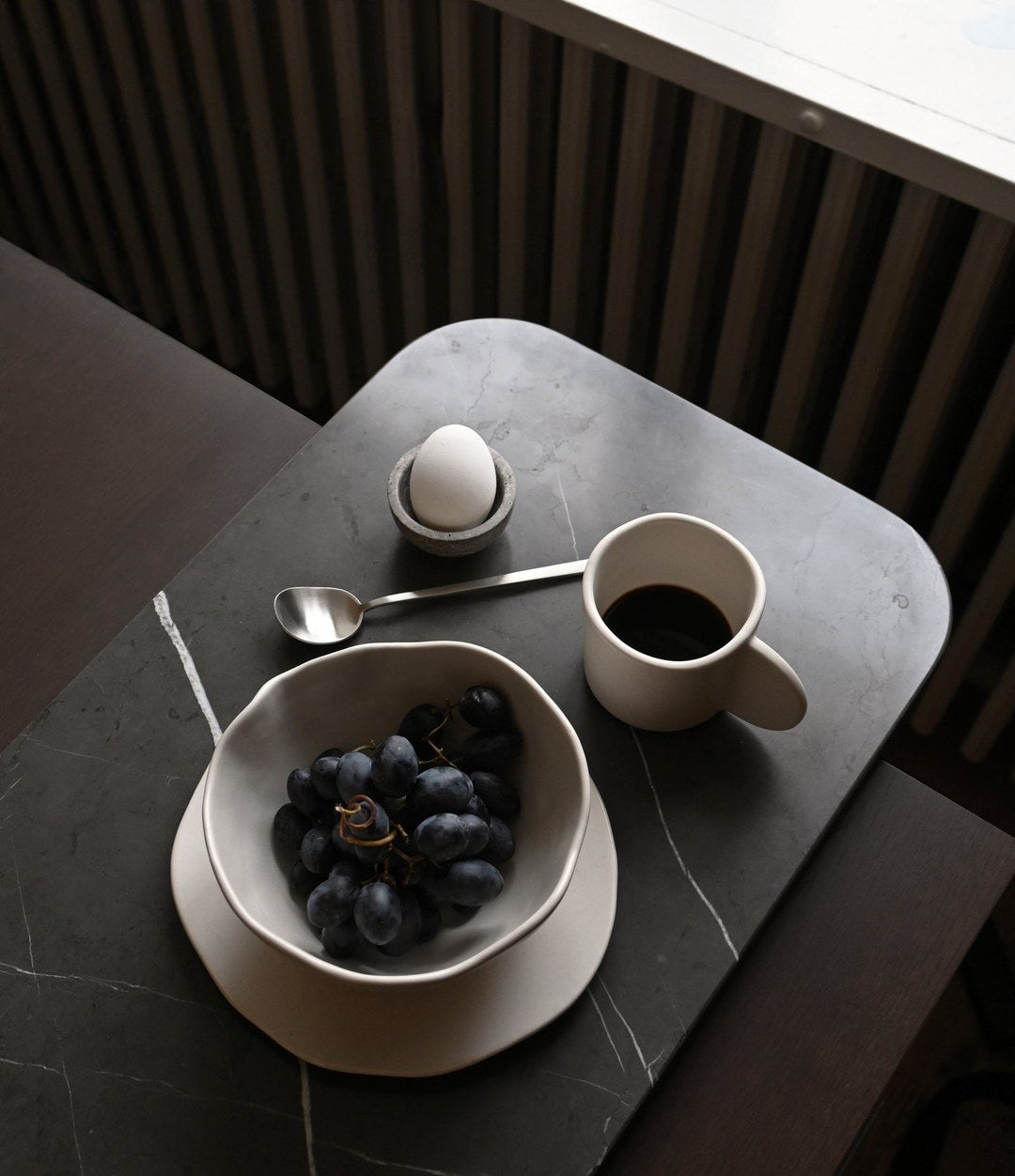 Kogei Long Spoon by 101 Copenhagen in Brushed Steel in a styled interior, view 3 – In Dubai by WSPR