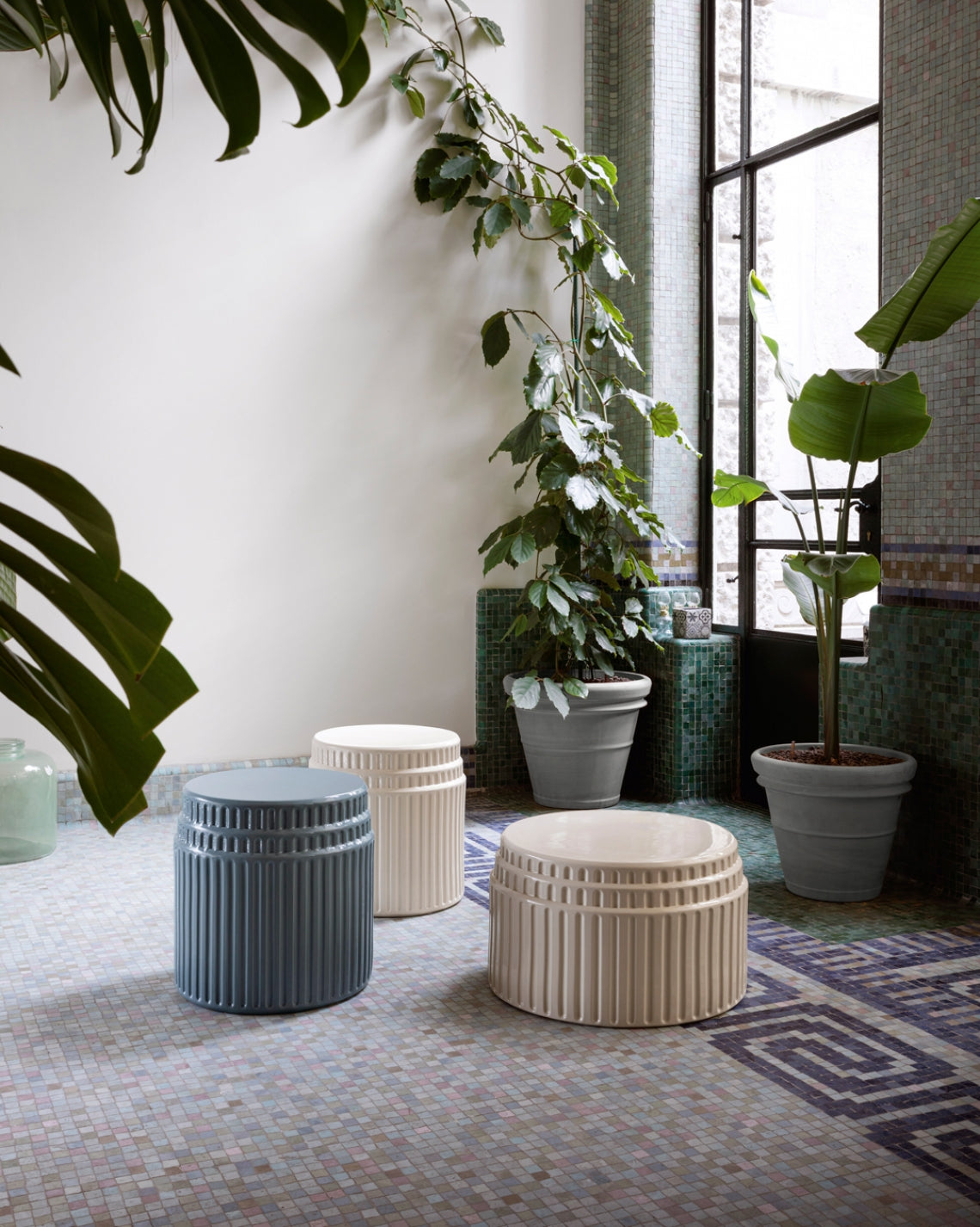 Kolos Coffee Table by Miniforms styled among plants on a mosaic floor, in blue and cream ceramic – In Dubai by WSPR