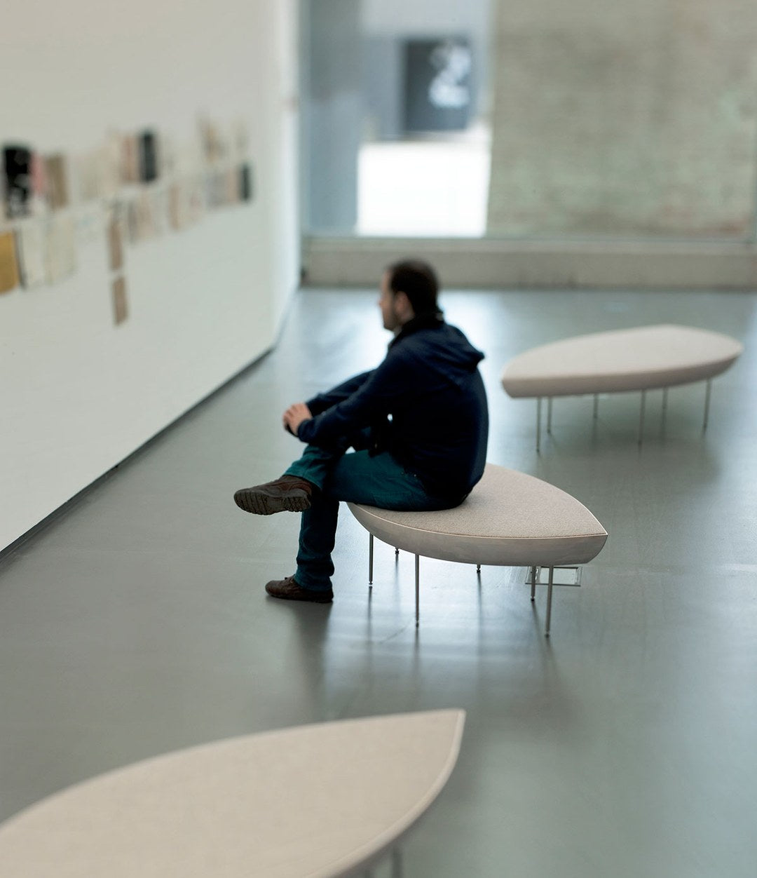 Konoha Bench by Sancal in a gallery beside a wall of drawings – In Dubai by WSPR