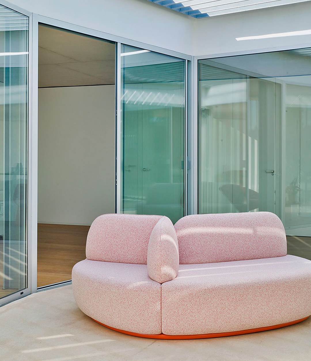 La Isla Bench by Sancal in pink in a glass pavilion, wide view – In Dubai by WSPR