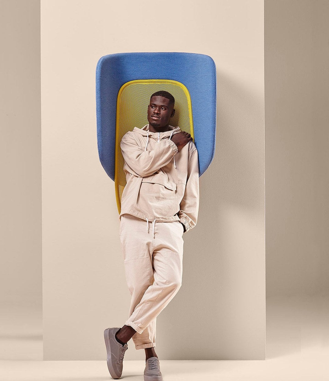Lapso Acoustic Cabin by Sancal in blue and yellow with a man on a call – In Dubai by WSPR