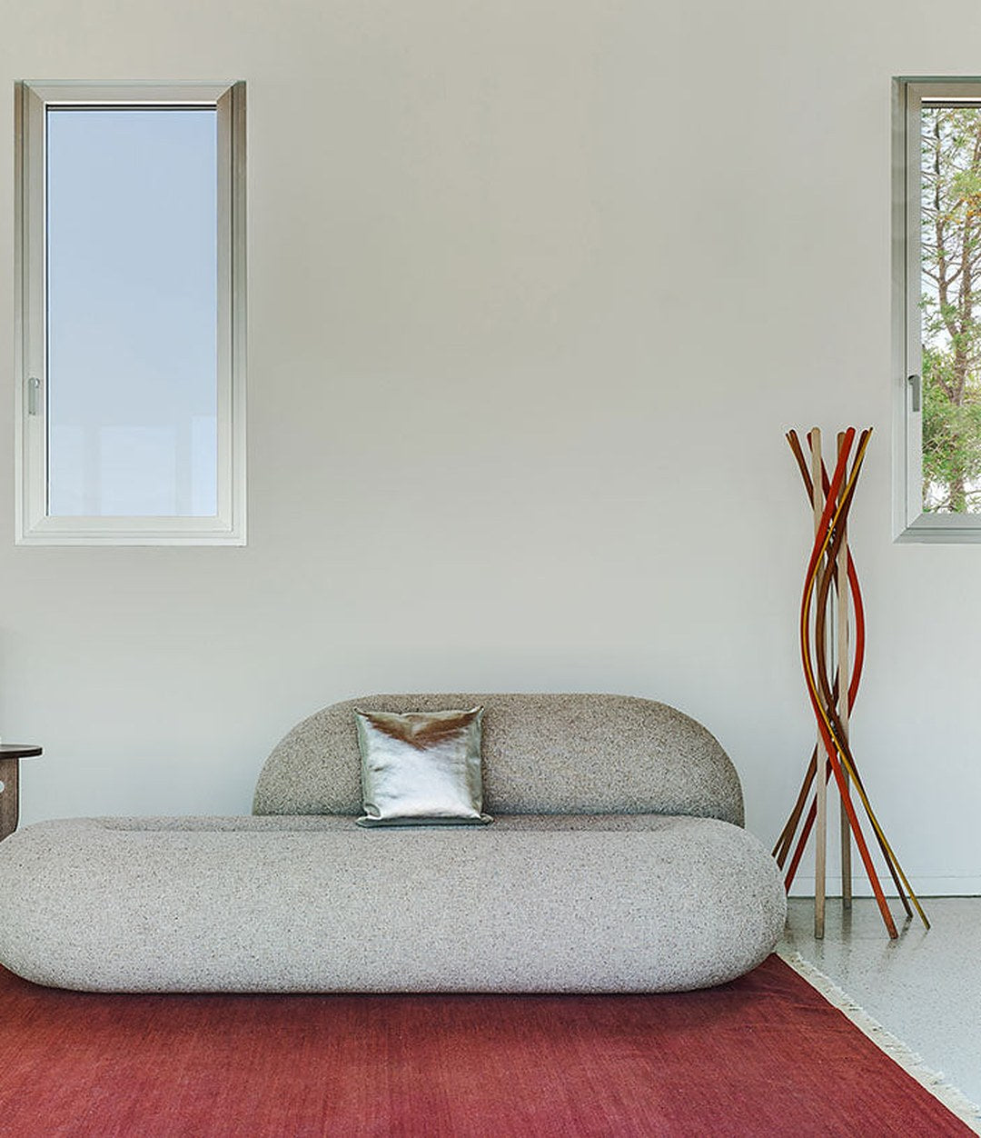 Loop Sofa by Sancal in grey on a red rug – In Dubai by WSPR