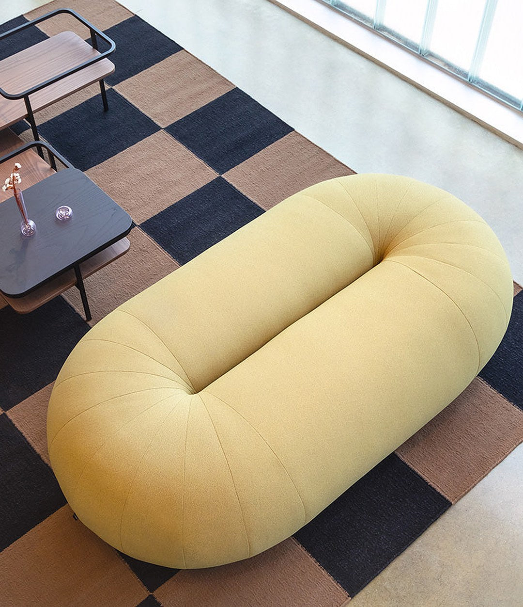 Loop Sofa by Sancal pouf in yellow on a checked rug – In Dubai by WSPR