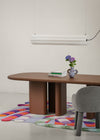 Lucerama Pendant by Miniforms styled above a brown dining table with a bouquet of flowers – In Dubai by WSPR