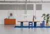 Lucerama Pendant by Miniforms styled above a wooden table with blue chairs in a studio – In Dubai by WSPR