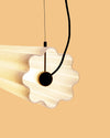 Lucerama Pendant by Miniforms in White Moon, close-up of the wavy shade end on a peach background – In Dubai by WSPR