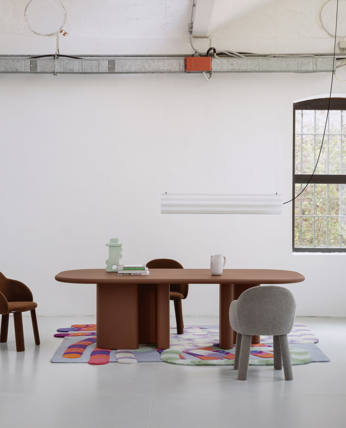 Lucerama Pendant by Miniforms styled above a long dining table in a white loft space – In Dubai by WSPR