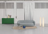 Lucerama Floor Lamp by Miniforms styled in a white studio with a grey sofa and a green cabinet – In Dubai by WSPR