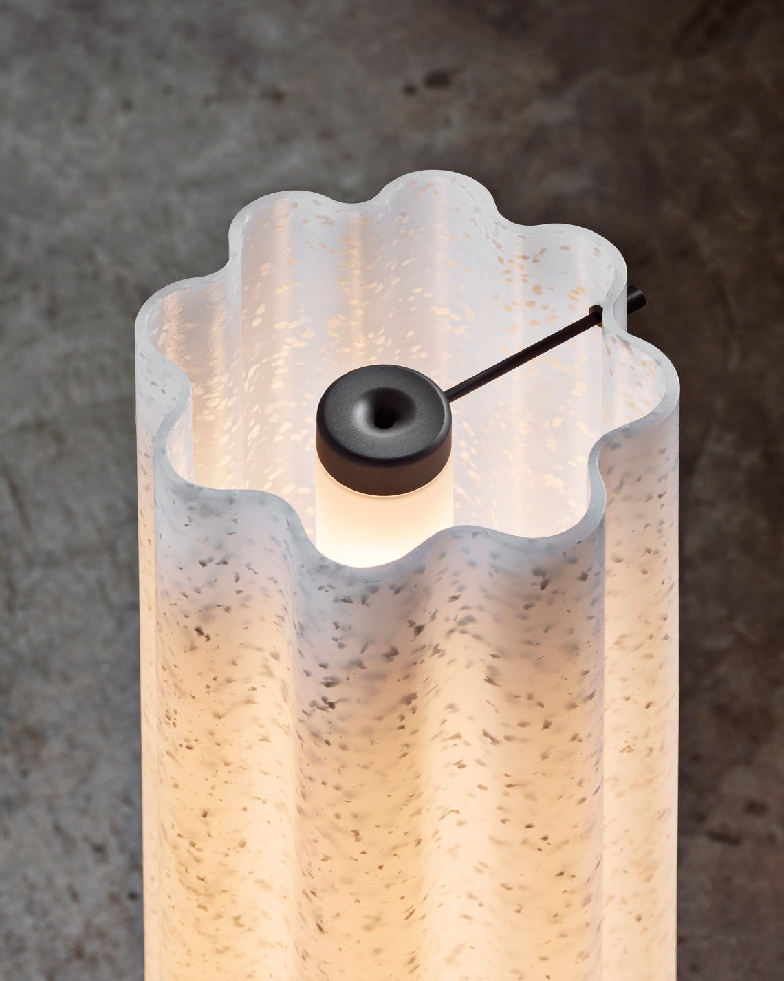 Lucerama Floor Lamp by Miniforms styled in a close view of the wavy shade and its lit top – In Dubai by WSPR