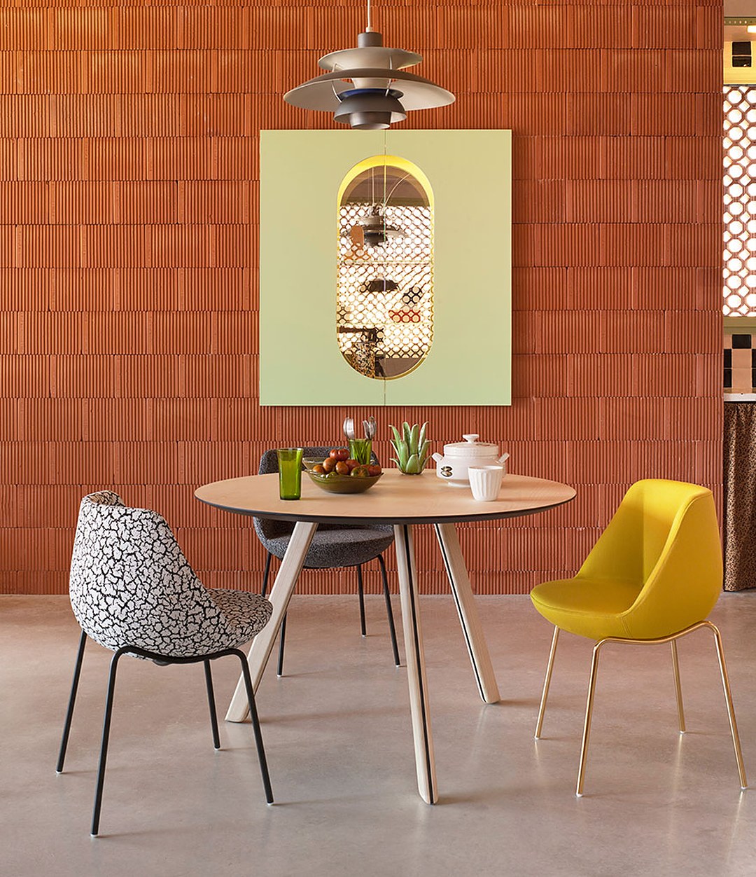 Magnum Chair by Sancal around a dining table in a brick room – In Dubai by WSPR