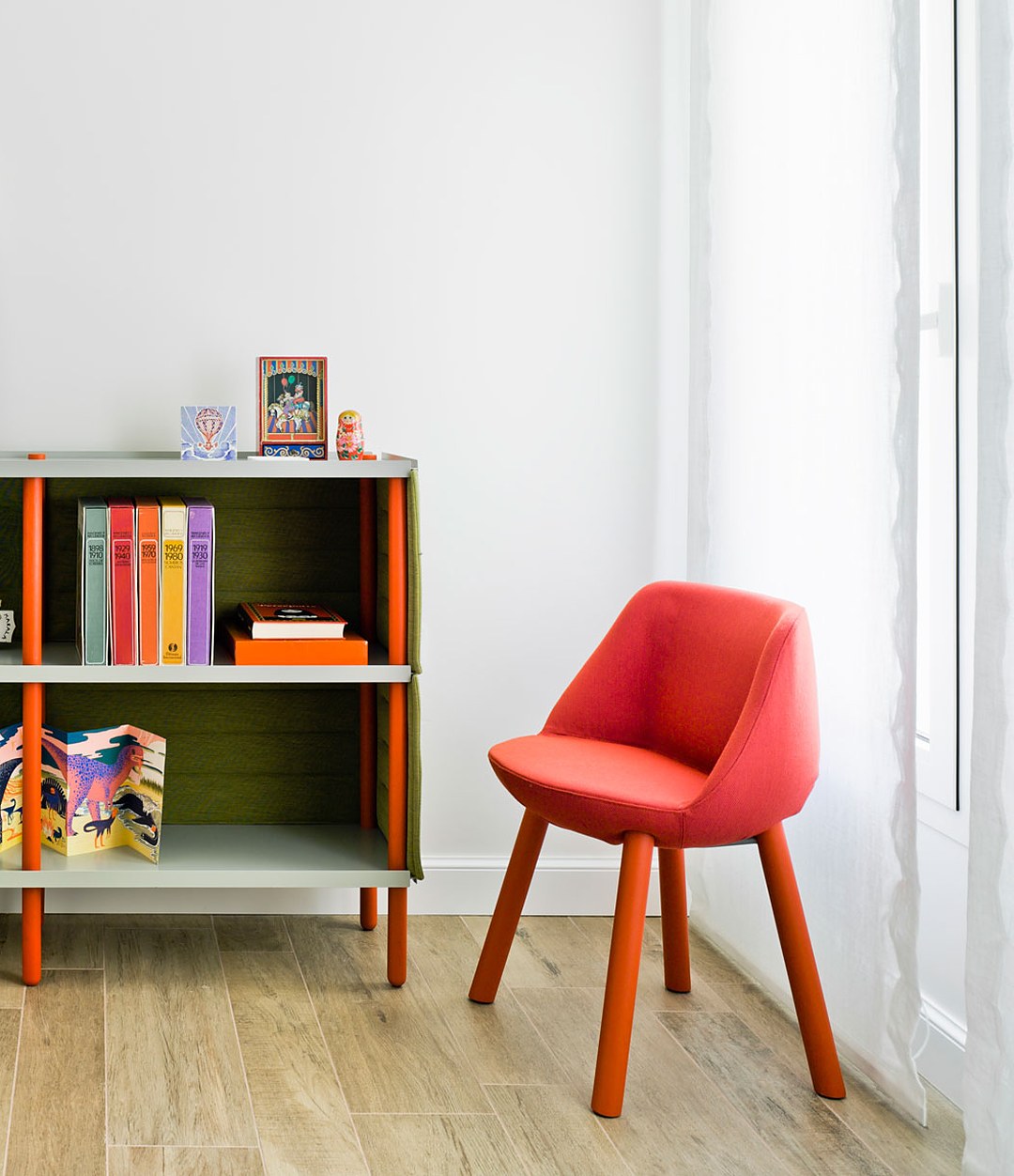 Magnum Chair by Sancal in red beside a bookcase – In Dubai by WSPR