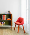 Magnum Chair by Sancal in red beside a bookcase – In Dubai by WSPR