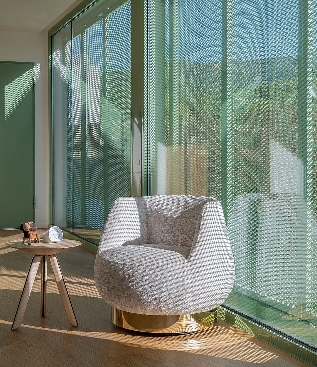 Magnum Lounge Chair by Sancal in a patterned fabric by a window – In Dubai by WSPR