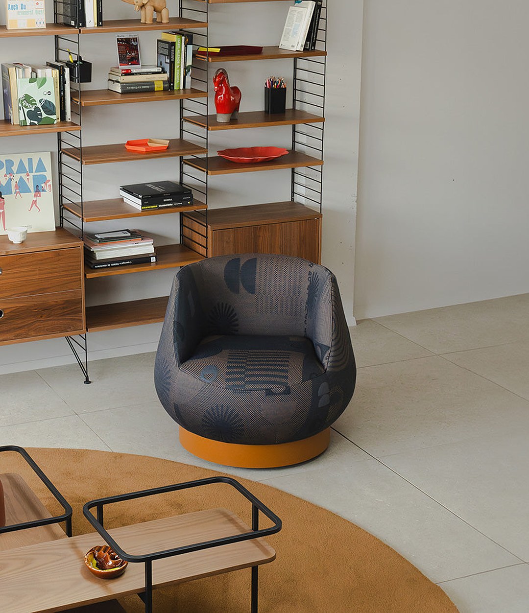 Magnum Lounge Chair by Sancal in charcoal beside a bookcase – In Dubai by WSPR