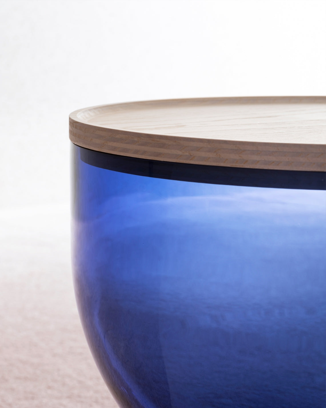 Mastea Coffee Table by Miniforms, close-up of a blue glass body with a light wood top – In Dubai by WSPR
