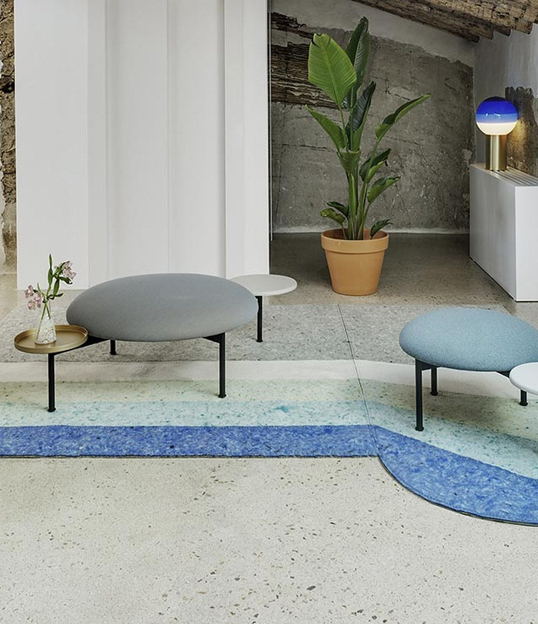 Meeting Point Pouf by Sancal in grey on a blue rug – In Dubai by WSPR