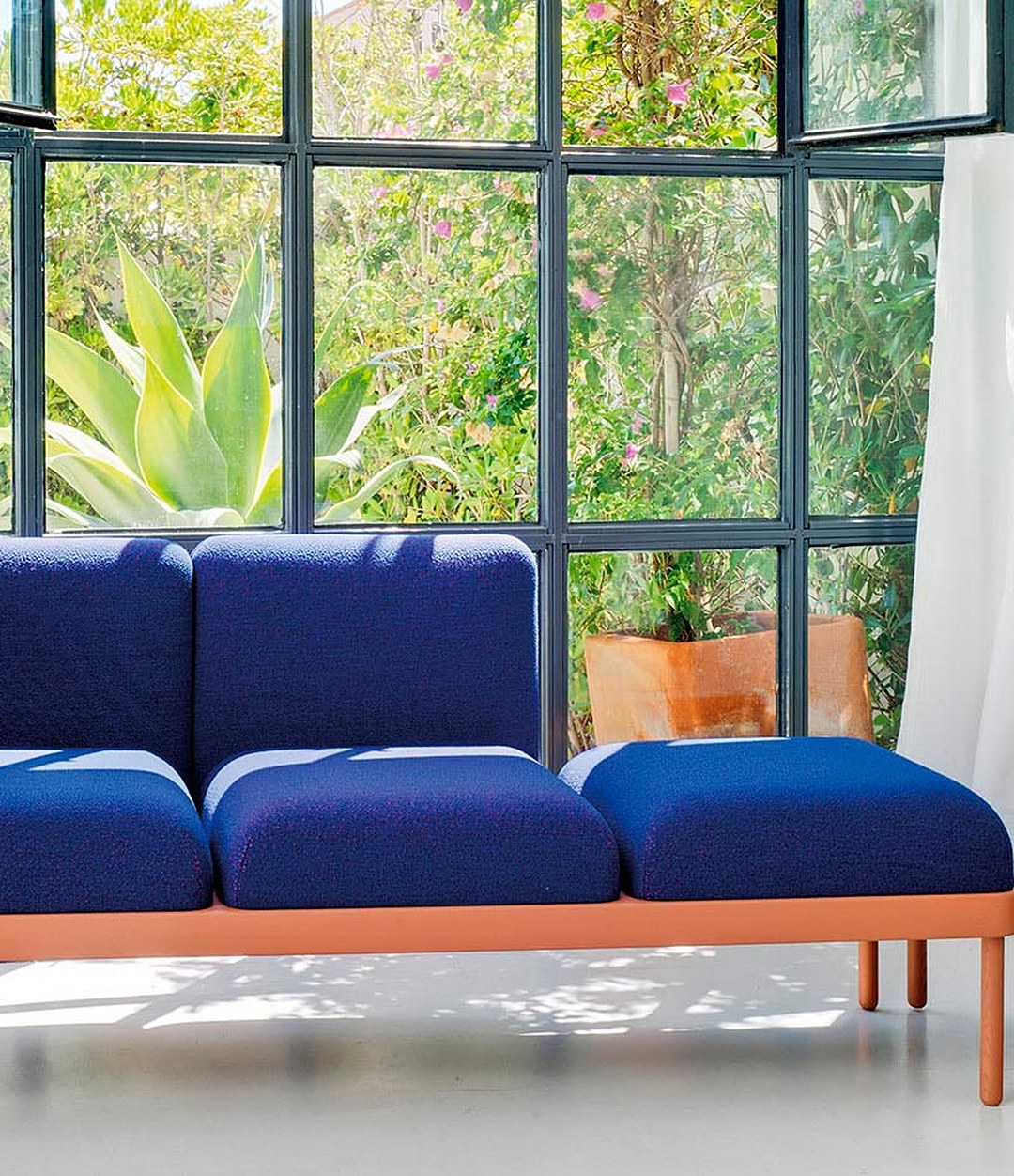 Mosaico Sofa by Sancal in blue by a window – In Dubai by WSPR