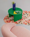 Nami Coffee Table by Miniforms in green lacquer, styled on a patterned rug beside a pink bouclé chair – In Dubai by WSPR