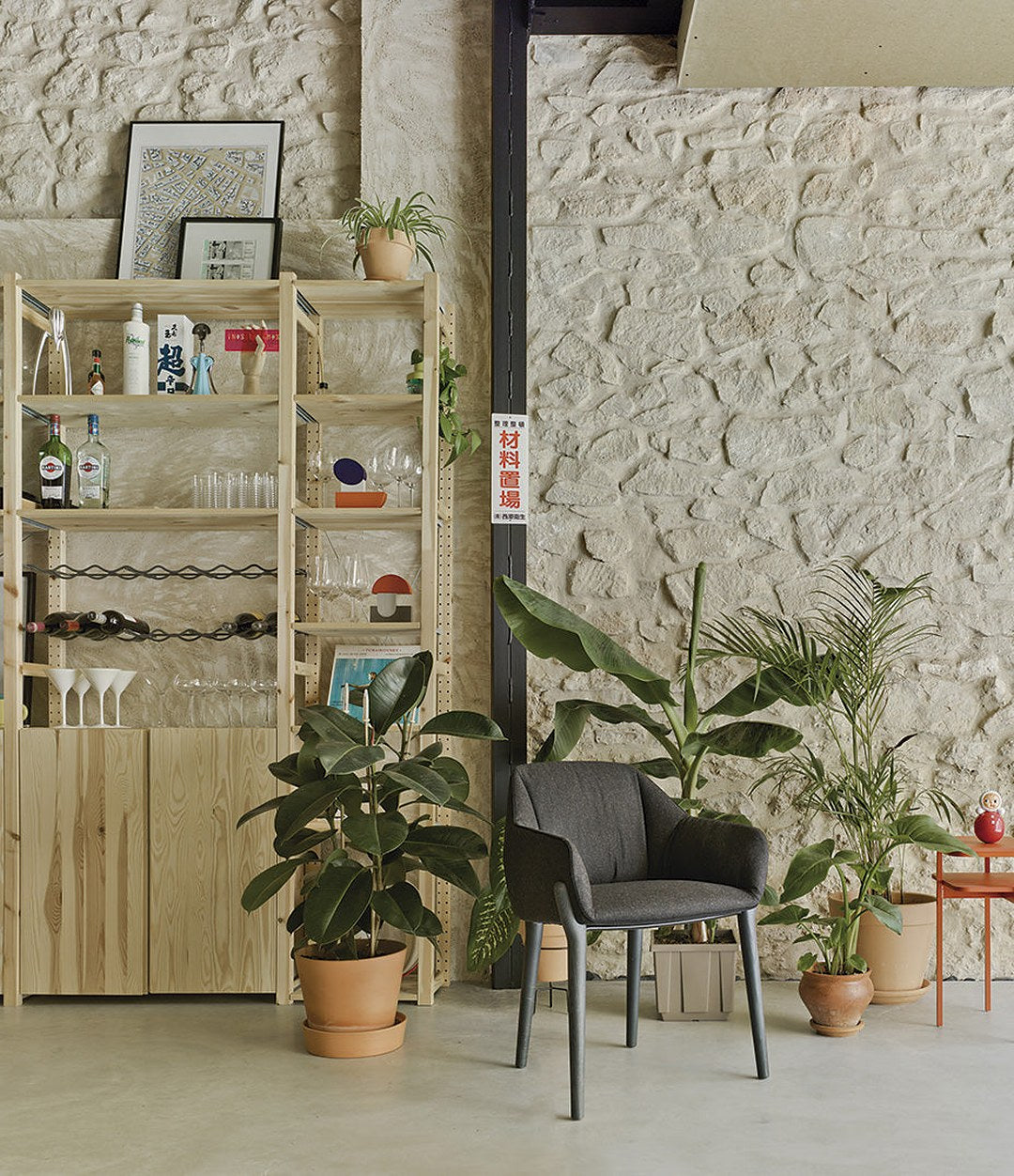 Nido Chair by Sancal in black by a plant-filled shelf – In Dubai by WSPR