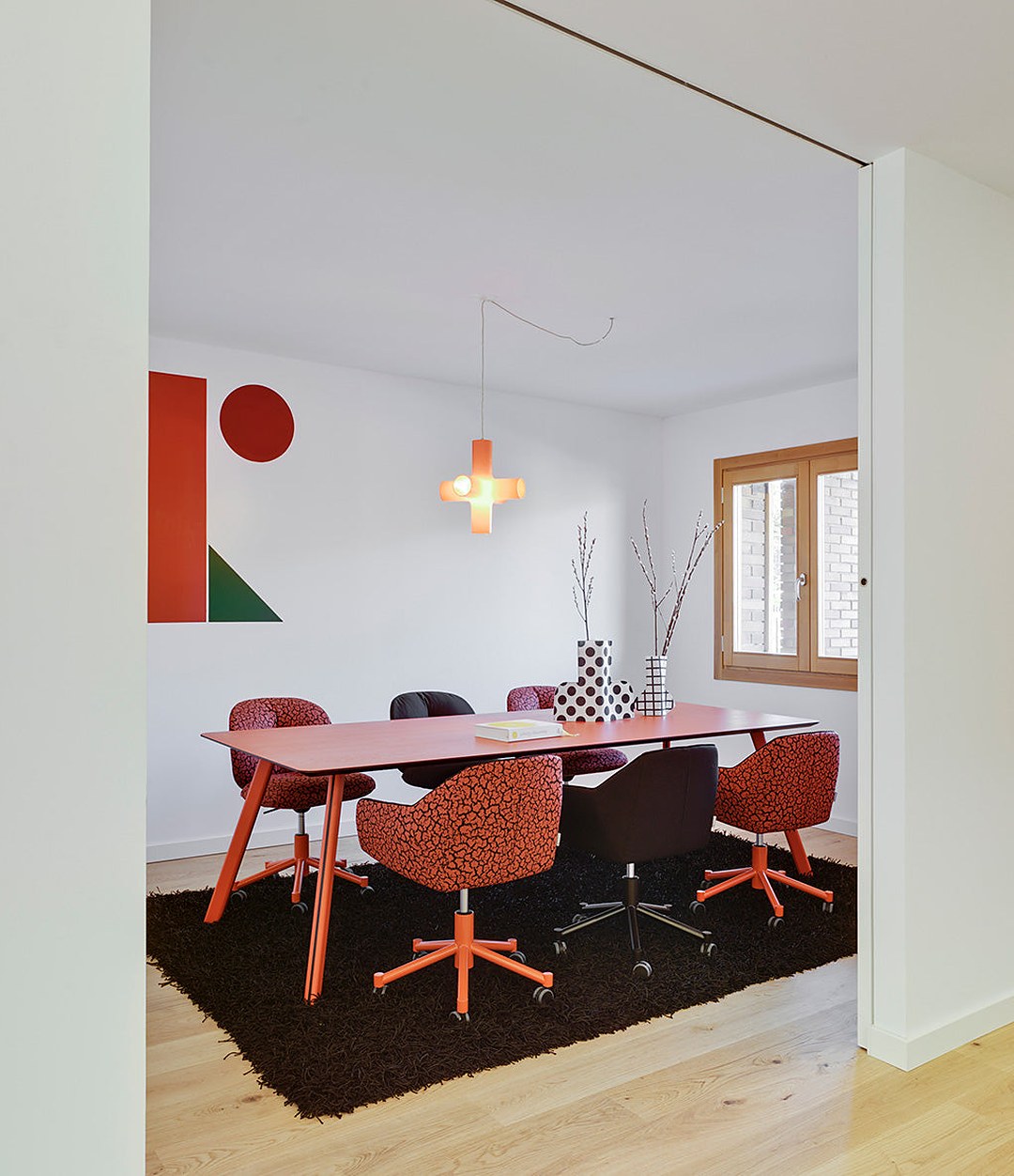 Nido Chair by Sancal in a meeting room with red wheeled bases – In Dubai by WSPR