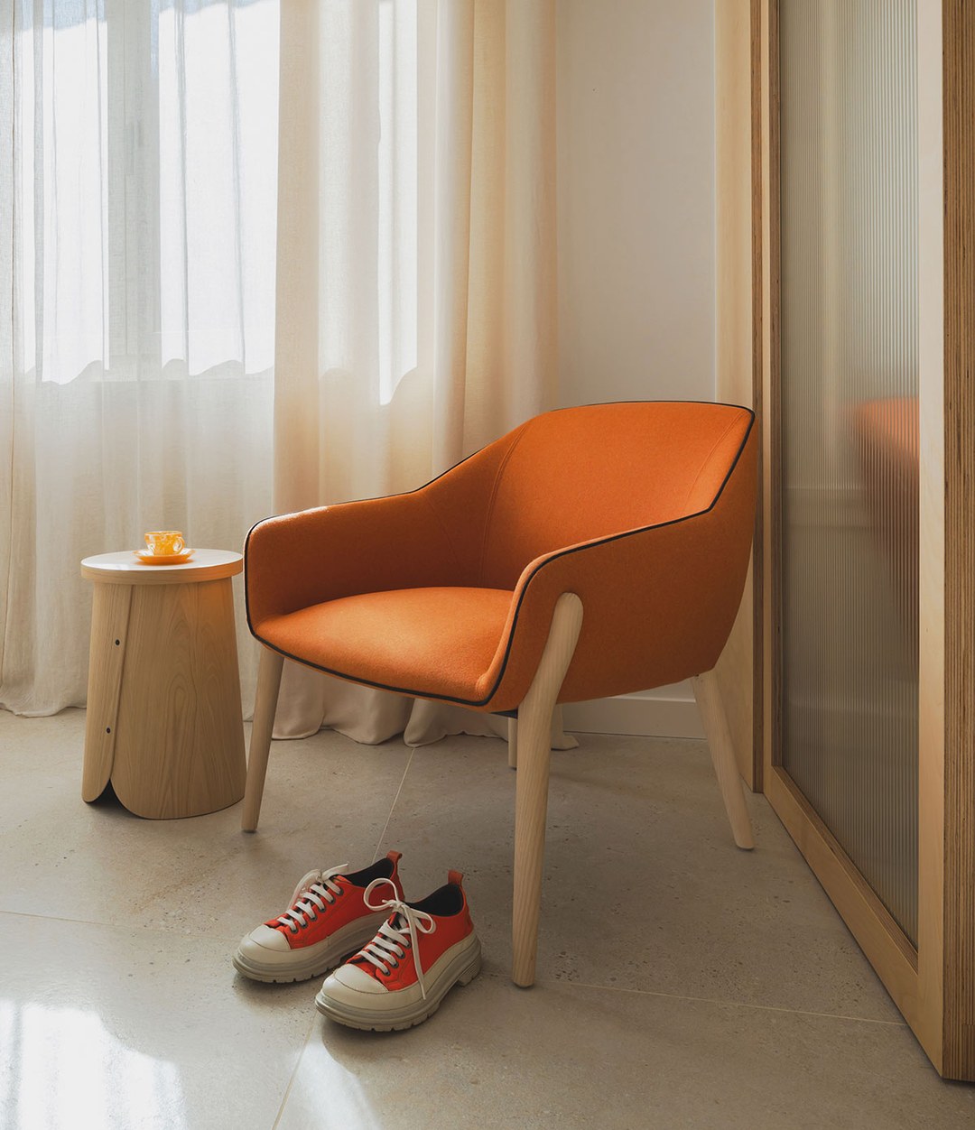 Nido Small Armchair by Sancal in orange by a window – In Dubai by WSPR