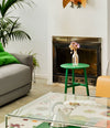 Nudo Side Table by Sancal in green by a fireplace – In Dubai by WSPR
