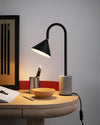 Ozz Desk Lamp by Miniforms styled on a wooden desk with a bowl and pencil pot, close view – In Dubai by WSPR
