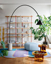Ozz Floor Lamp by Miniforms in black with a concrete base, styled in a living room with open shelving and plants – In Dubai by WSPR