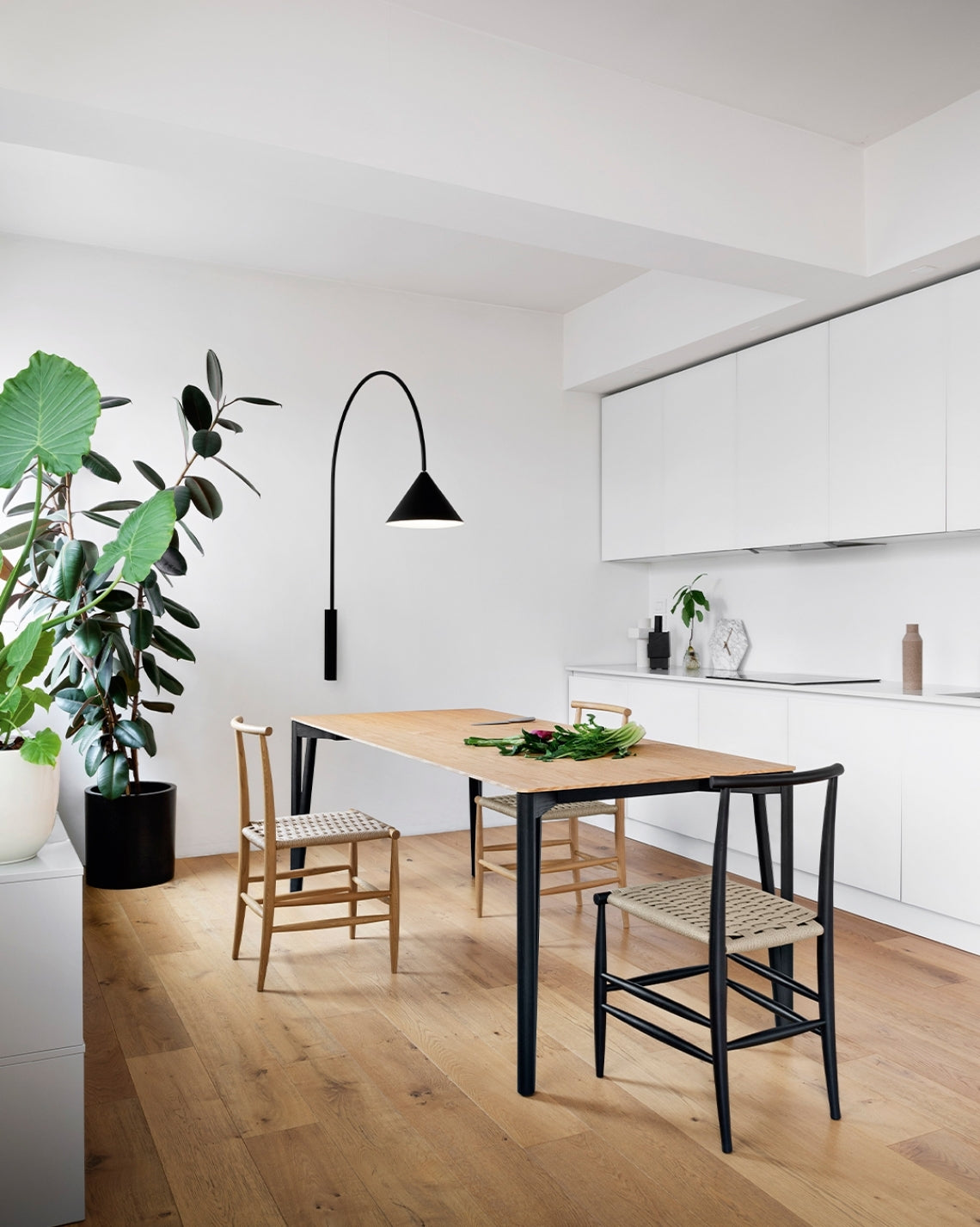 Ozz Wall Lamp by Miniforms in black, styled in a bright open-plan kitchen – In Dubai by WSPR