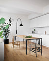 Ozz Wall Lamp by Miniforms in black, styled in a bright open-plan kitchen – In Dubai by WSPR