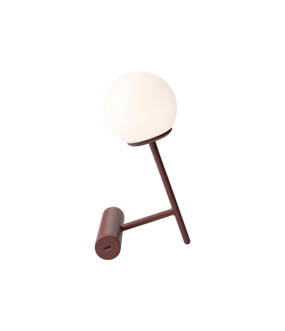 Phare Table Lamp by Audo in Burned Red, angled view with glowing globe – In Dubai by WSPR