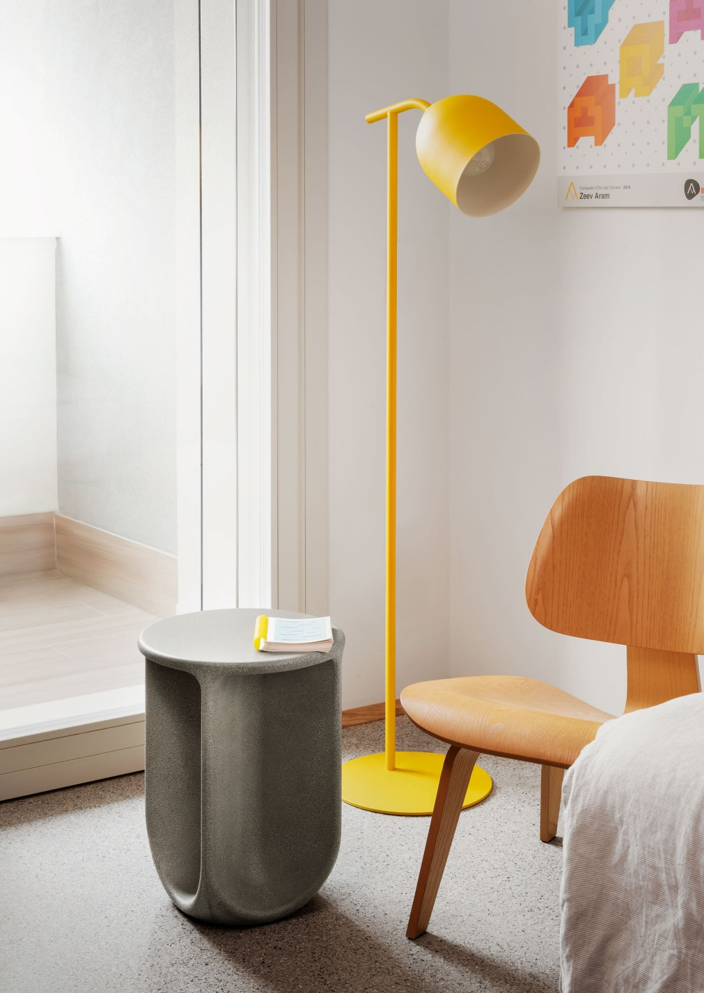 Pinto Coffee Table by Miniforms in a grey concrete finish beside a yellow floor lamp and an oak chair – In Dubai by WSPR
