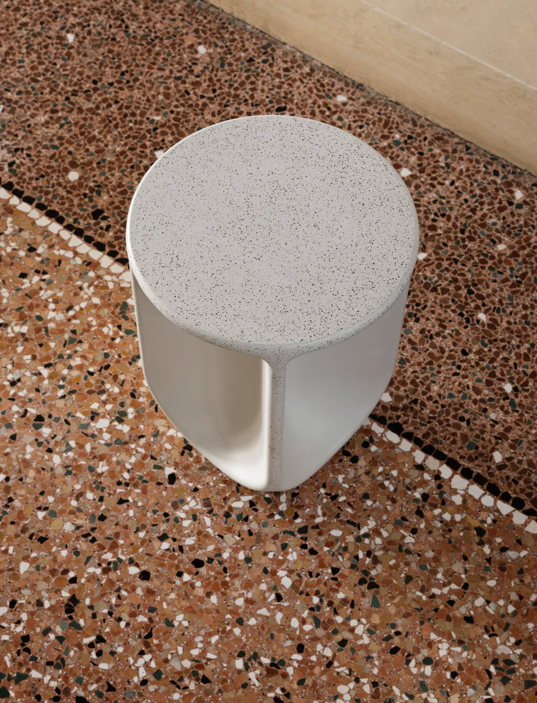 Pinto Coffee Table by Miniforms in a pale concrete finish, seen from above on a terrazzo floor – In Dubai by WSPR