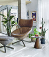 Pion Side Table by Sancal in brown by a leather lounge chair, wide view – In Dubai by WSPR