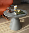 Pion Side Table by Sancal in grey beside an orange sofa – In Dubai by WSPR
