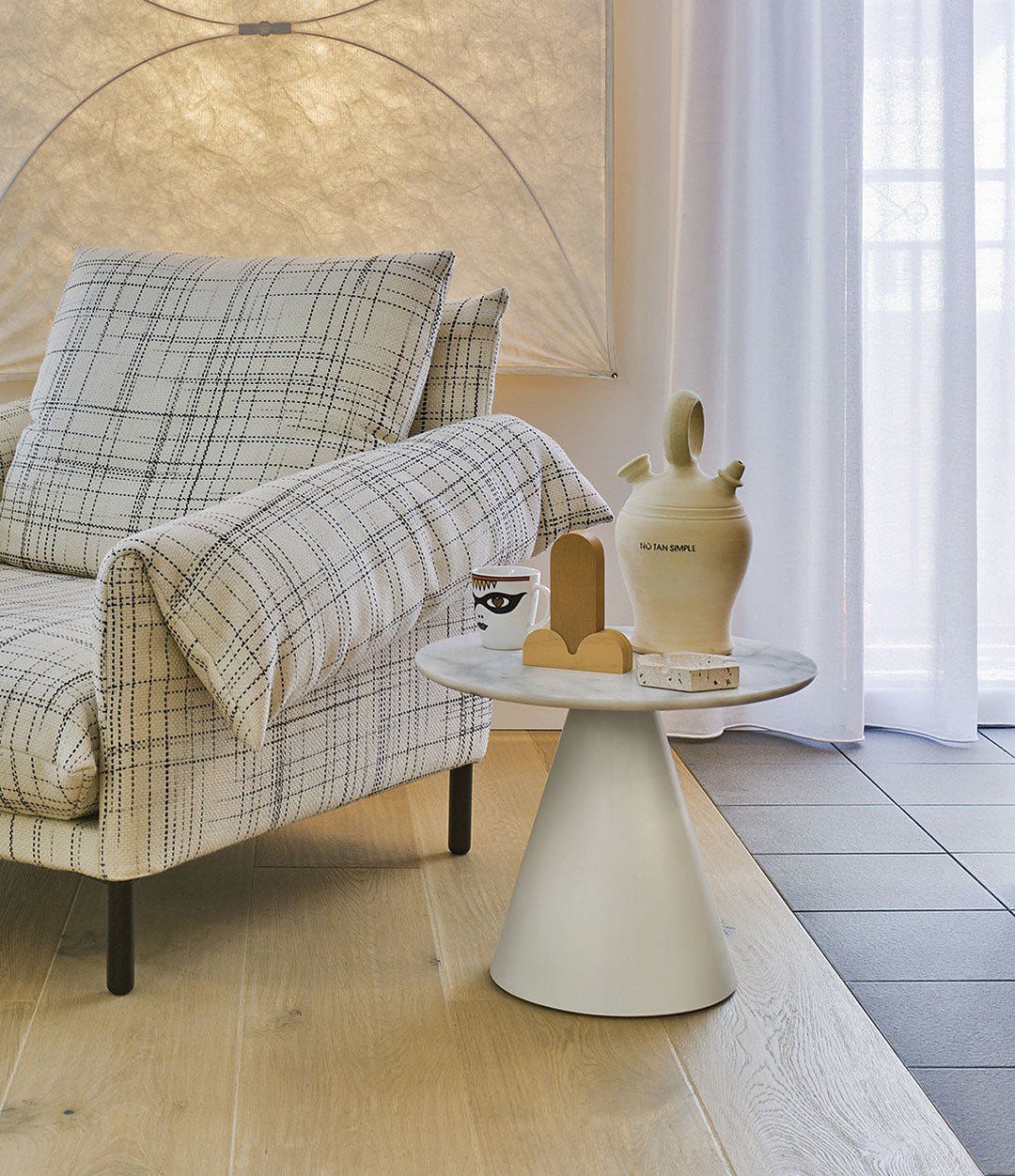 Pion Side Table by Sancal in white beside a checked sofa – In Dubai by WSPR
